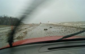 Rocks left by crashing waves are strewn across of highway 57.