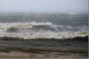 Stormy waves crashing onto a devils lake beach.